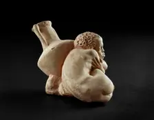 Terracotta figurine of an Afro-Hellenic boy, possibly a slave with Rhodian amphora, 4th century BC