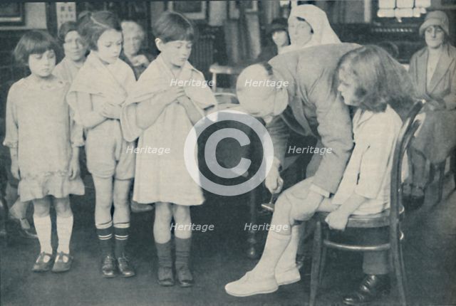 ' Testing the patella reflex for indication of nervous disease', c1935. Artist: Unknown.