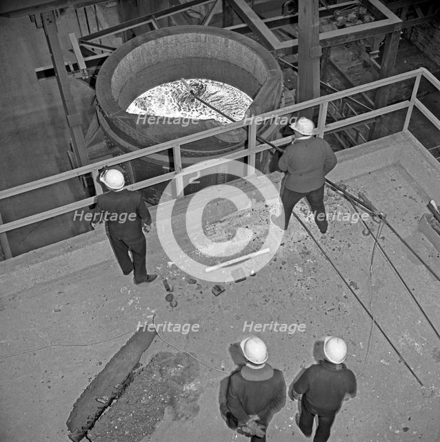Testing the temperature of molten steel, Park Gate, Rotherham, South Yorkshire, 1964. Creator: Michael Walters.