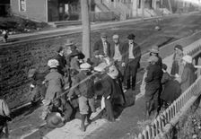 Thanksgiving Maskers scramble for pennies, between c1910 and c1915. Creator: Bain News Service