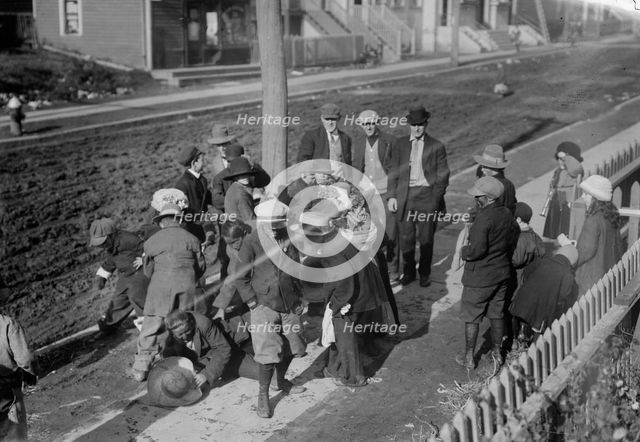 Thanksgiving Maskers scramble for pennies, between c1910 and c1915. Creator: Bain News Service.