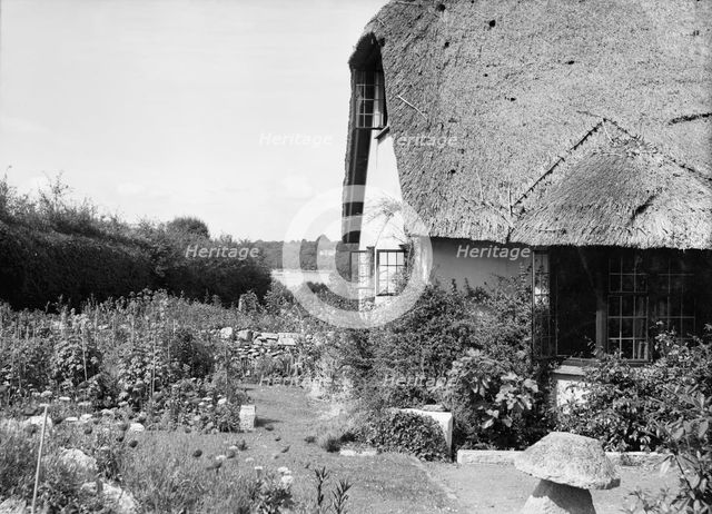 Thatched cottage and garden, c1935. Creator: Kirk & Sons of Cowes.