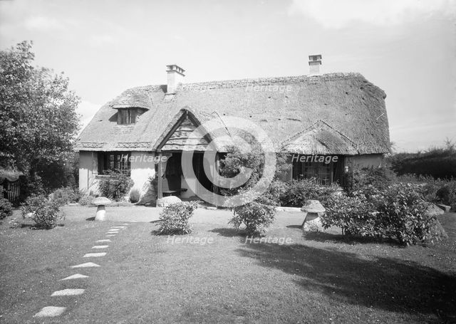Thatched cottage and garden, c1935. Creator: Kirk & Sons of Cowes.