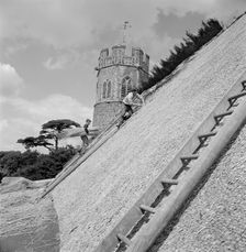 Thatchers at work on the roof of St Peter's Church, Theberton, Suffolk, 1956 Artist: John Gay