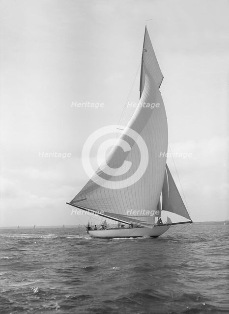 The 15-metre cutter 'Ostara' sailing downwind, 1911. Creator: Kirk & Sons of Cowes.
