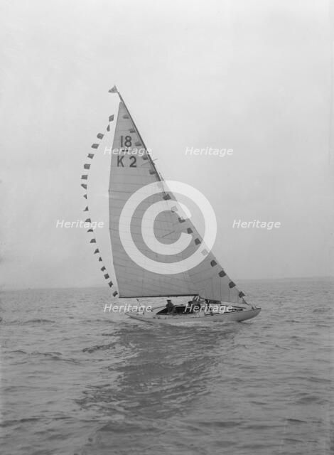 The 18-foot keelboat 'Prudence' (K2) with prize flags, 1922. Creator: Kirk & Sons of Cowes.