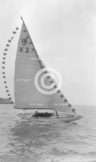 The 18-foot keelboat 'Prudence' (K2) with prize flags, 1922. Creator: Kirk & Sons of Cowes.