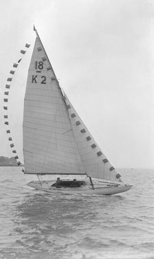 The 18-foot keelboat Prudence (K2) with prize flags, 1922. Creator: Kirk & Sons of Cowes