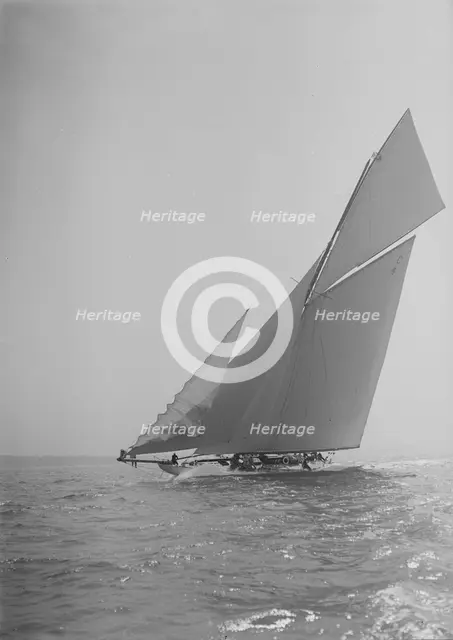 The 19-metre cutter 'Norada' sailing close-hauled, jib flapping, 1911. Creator: Kirk & Sons of Cowes.