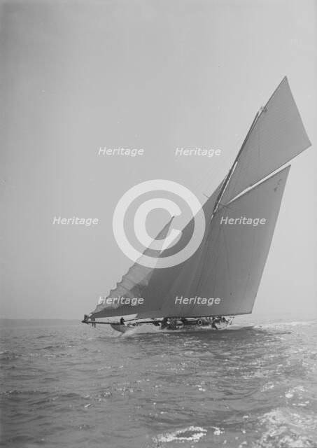 The 19-metre cutter 'Norada' sailing close-hauled, jib flapping, 1911. Creator: Kirk & Sons of Cowes.
