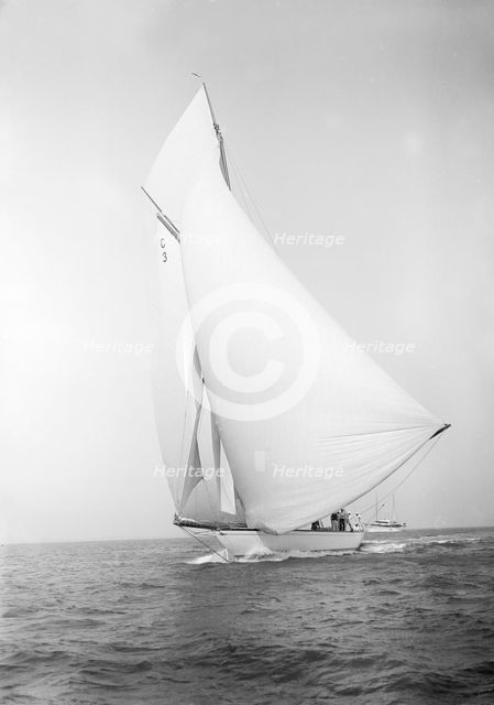 The 19-metre class 'Corona' running downwind, 1911. Creator: Kirk & Sons of Cowes.