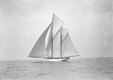 The 118 foot racing yacht Cariad sailing with spinnaker, 1911. Creator: Kirk & Sons of Cowes