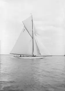 The 12 Metre cutter Alachie sailing in gentle winds, 1913. Creator: Kirk & Sons of Cowes
