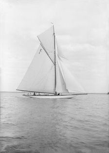 The 12 Metre cutter Alachie sailing in gentle winds, 1913. Creator: Kirk & Sons of Cowes