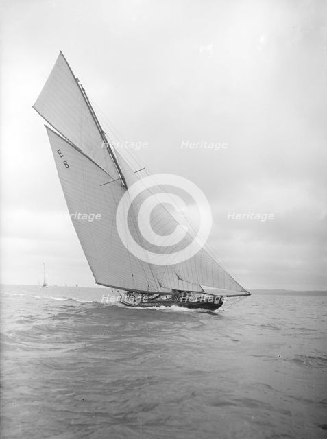The 12 Metre sailing yacht 'Rollo' racing upwind, 1911. Creator: Kirk & Sons of Cowes.