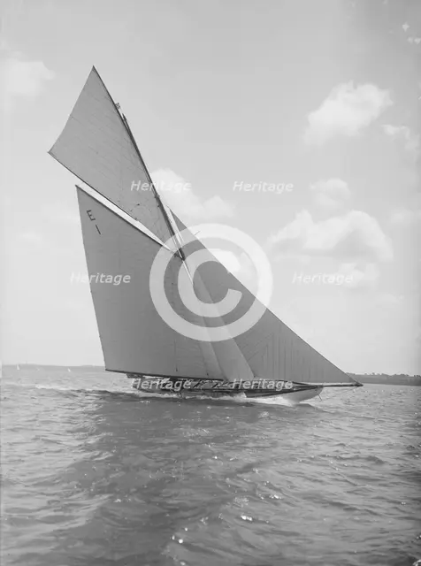 The 12 Metre yacht 'Alachie' makes swift progress upwind, 1911. Creator: Kirk & Sons of Cowes.