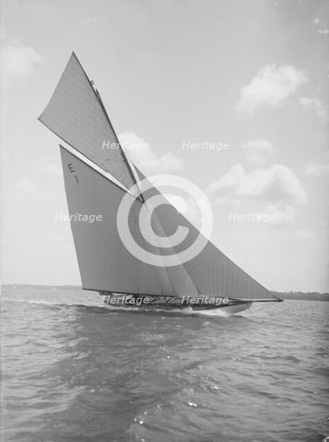 The 12 Metre yacht 'Alachie' makes swift progress upwind, 1911. Creator: Kirk & Sons of Cowes.