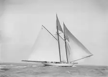 The 250 ton schooner Germania sailing downwind with spinnaker, 1912. Creator: Kirk & Sons of Cowes