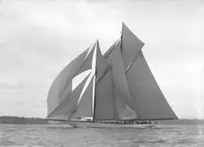 The 250 ton schooner Germania sails downwind under spinnaker, 1911. Creator: Kirk & Sons of Cowes