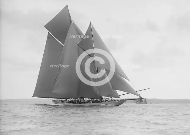 The 250 ton schooner 'Germania' sails on a reach, 1913. Creator: Kirk & Sons of Cowes.