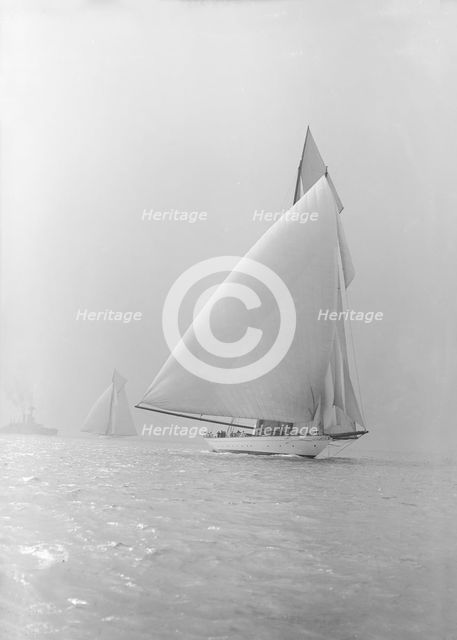 The 250 ton schooner 'Germania' running under spinnaker, 1913. Creator: Kirk & Sons of Cowes.