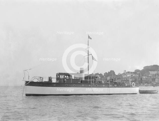 The 28 ton motor yacht 'Edina' at anchor, 1921. Creator: Kirk & Sons of Cowes.
