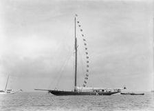 The 221 ton cutter Britannia at anchor with prize flags, 1921. Creator: Kirk & Sons of Cowes