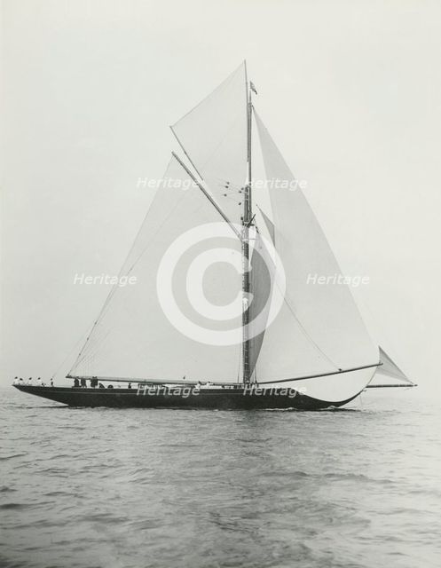 The 221 ton gaff-rigged cutter 'Britannia' sailing under spinnaker. Creator: Kirk & Sons of Cowes.