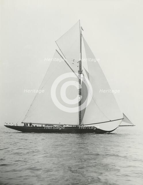 The 221 ton gaff-rigged cutter 'Britannia' sailing under spinnaker. Creator: Kirk & Sons of Cowes.