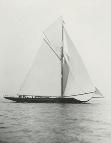 The 221 ton gaff-rigged cutter Britannia sailing under spinnaker. Creator: Kirk & Sons of Cowes