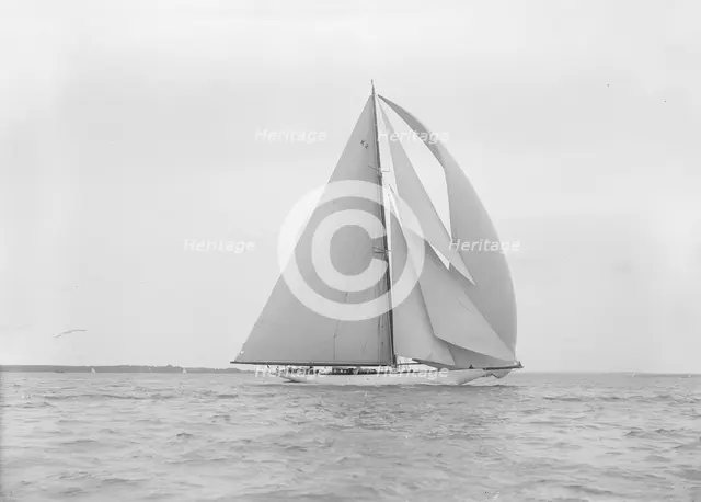 The 23-metre cutter 'Astra' sailing with spinnaker.  Creator: Kirk & Sons of Cowes.