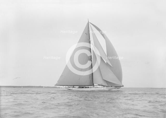 The 23-metre cutter 'Astra' sailing with spinnaker.  Creator: Kirk & Sons of Cowes.