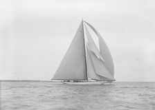 The 23-metre cutter Astra sailing with spinnaker. Creator: Kirk & Sons of Cowes
