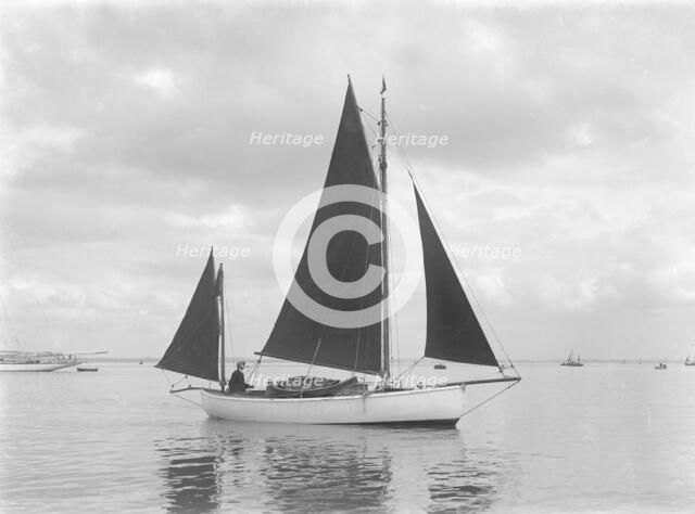 The 4 ton yawl 'Mandy' under sail, 1922. Creator: Kirk & Sons of Cowes.
