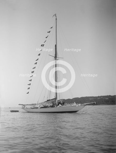The 40-rater cutter 'Carina' at anchor with flags, 1911. Creator: Kirk & Sons of Cowes.
