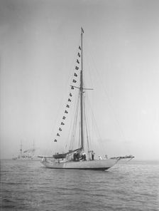 The 40-rater cutter Carina at anchor with flags, 1911. Creator: Kirk & Sons of Cowes