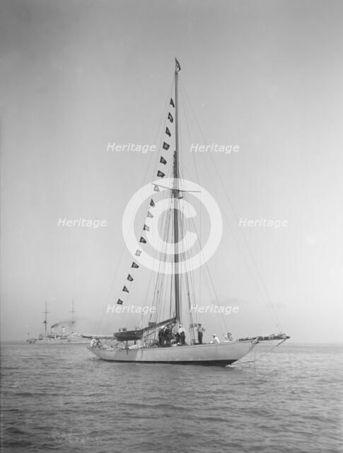 The 40-rater cutter 'Carina' at anchor with flags, 1911. Creator: Kirk & Sons of Cowes.