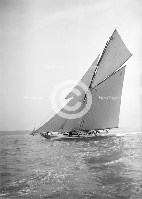 The 40-rater cutter 'Carina' sailing close-hauled, 1911. Creator: Kirk & Sons of Cowes.
