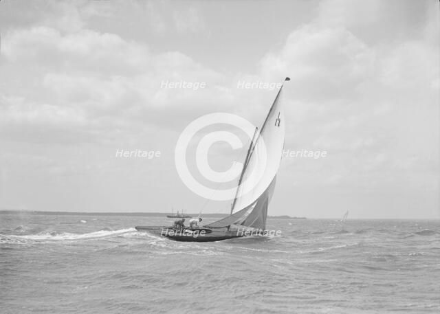 The 6 Metre class 'Ejnar' sailing downwind, 1911. Creator: Kirk & Sons of Cowes.