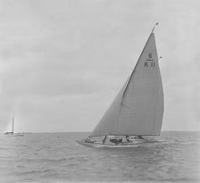 The 6 Metre class Freesia sailing close-hauled, 1921. Creator: Kirk & Sons of Cowes
