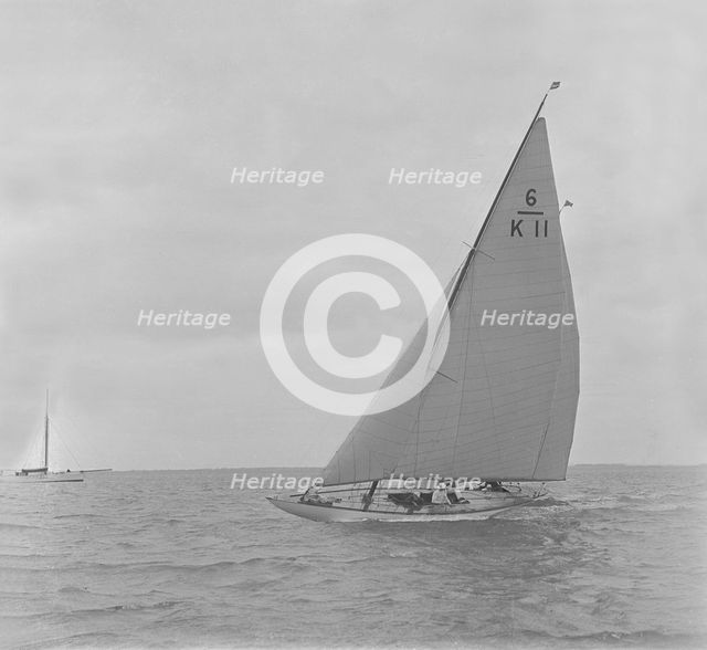 The 6 Metre class 'Freesia' sailing close-hauled, 1921. Creator: Kirk & Sons of Cowes.