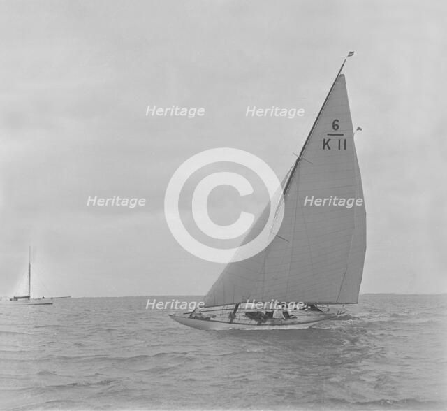 The 6 Metre class 'Freesia' sailing close-hauled, 1921. Creator: Kirk & Sons of Cowes.