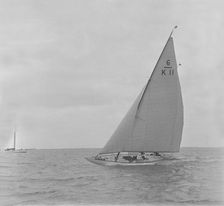 The 6 Metre class Freesia sailing close-hauled, 1921. Creator: Kirk & Sons of Cowes