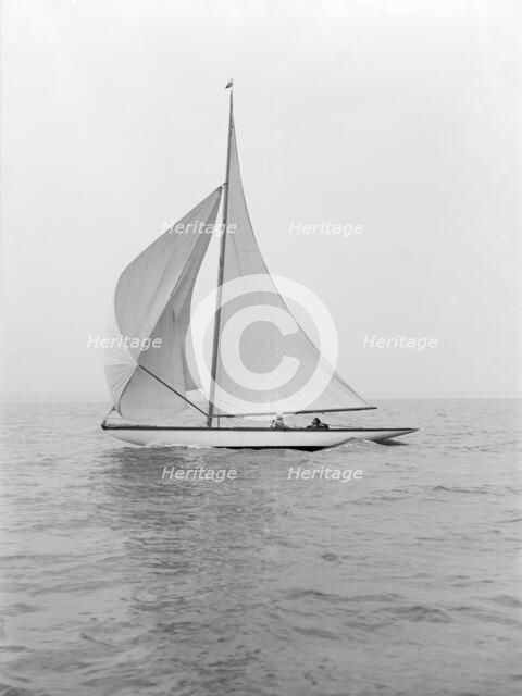 The 6 Metre class 'Marmi' sailing under spinnaker, 1914. Creator: Kirk & Sons of Cowes.