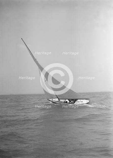 The 6 Metre class 'The Whim' sailing upwind, 1911. Creator: Kirk & Sons of Cowes.