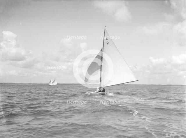 The 6 Metre 'Cynthia' running downwind under spinnaker, 1912. Creator: Kirk & Sons of Cowes.
