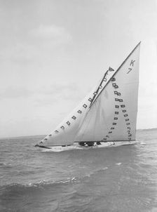 The 7 Metre Ginerva (K7) under sail with prize flags, 1912. Creator: Kirk & Sons of Cowes