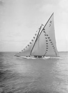 The 7 Metre Ginerva (K7) under sail with prize flags, 1912. Creator: Kirk & Sons of Cowes