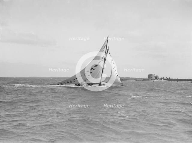 The 7 Metre 'Ginerva' (K7) under sail with prize flags, 1912. Creator: Kirk & Sons of Cowes.