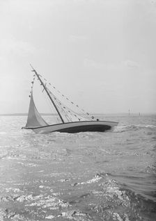 The 7 Metre Ginerva (K7) under sail with prize flags, 1912. Creator: Kirk & Sons of Cowes
